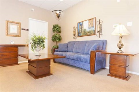a living room with a blue couch and a table