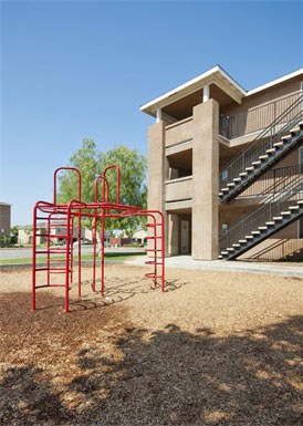 an empty playground in front of a building