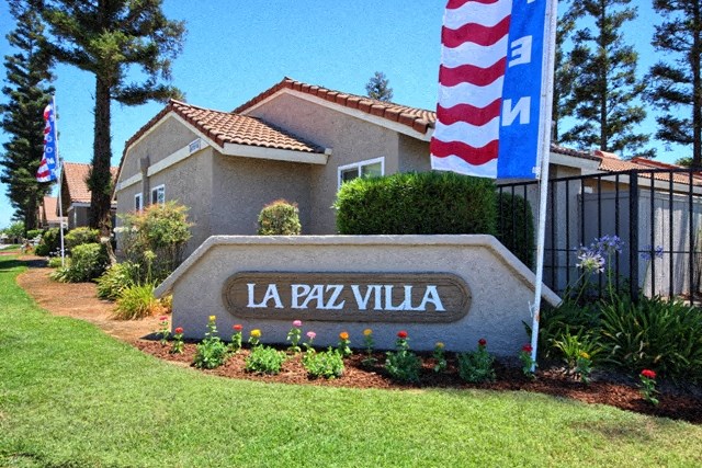 a house with a sign and a flag in front of it
