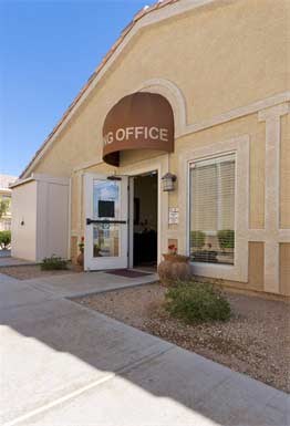 the front of a go office building with a brown sign