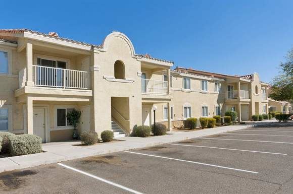 a row of apartments with a parking lot