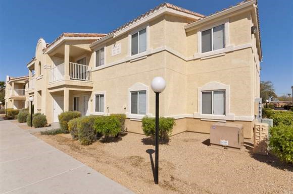 an apartment building with a street light in front of it