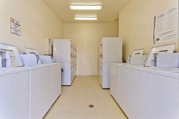 a row of white washing machines in a room