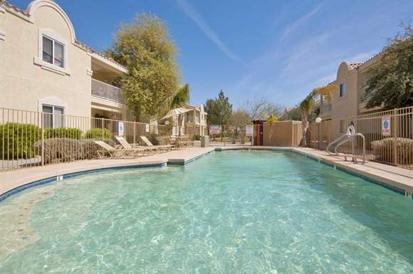a large swimming pool in front of a building