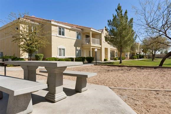 a group of benches in front of an apartment building