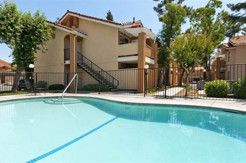 a swimming pool in front of an apartment building