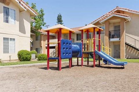 a playground with a blue and red slide