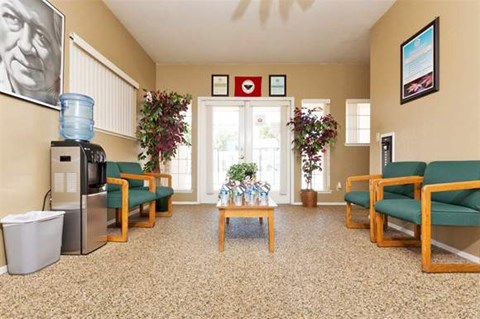 a living room with chairs and a coffee table