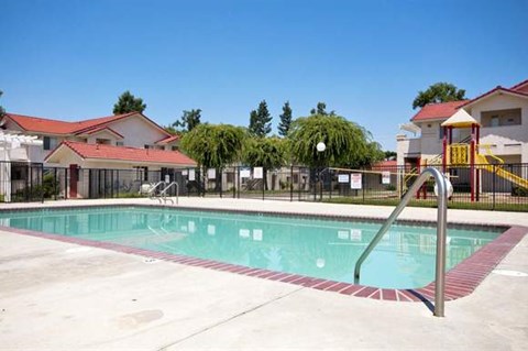 a swimming pool in front of some buildings