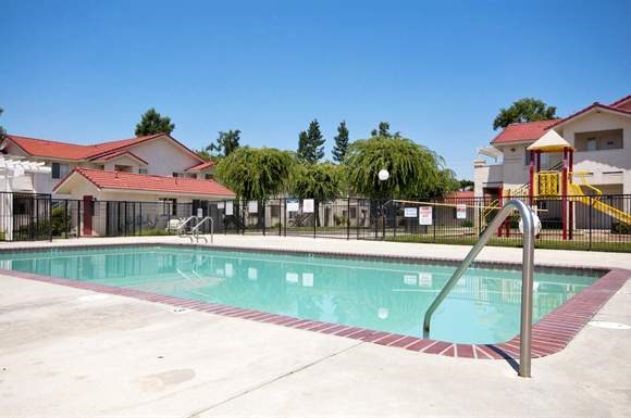a swimming pool in front of some buildings