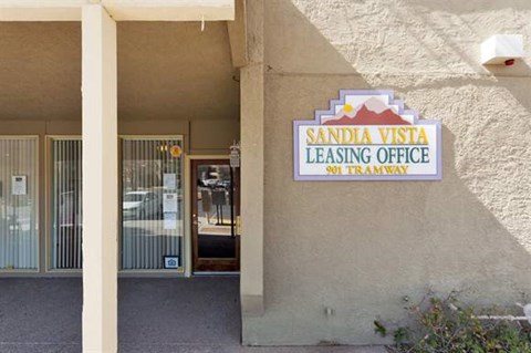 a leasing office sign on the side of a building