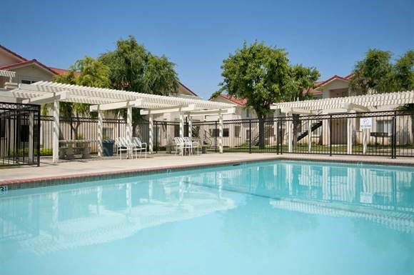 a large swimming pool with a fence around it