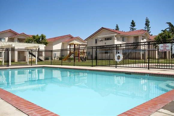 a swimming pool in front of a house