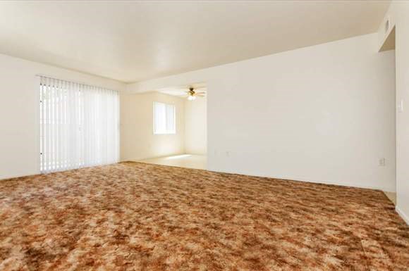 an empty living room with a large bed