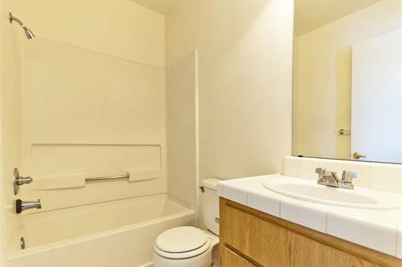 a bathroom with a sink toilet and a bath tub
