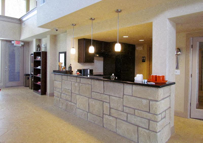 a large lobby with a stone bar in the middle