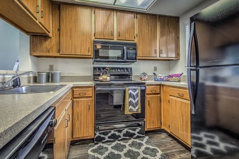 a kitchen with wooden cabinets and stainless steel appliances