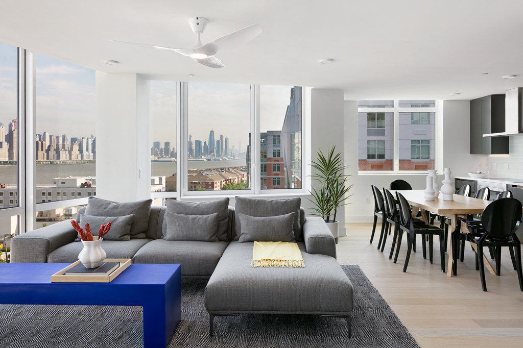 a living room with a gray couch and a blue coffee table