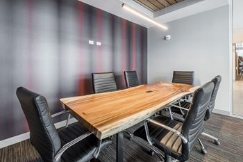 Conference room with long table and office chairs
