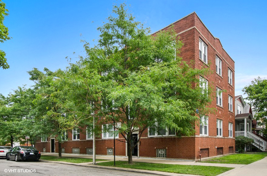a red brick building with trees in front of it