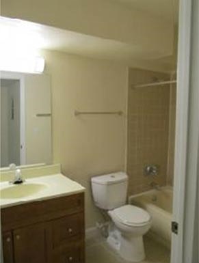 a bathroom with a toilet and a sink and a bath tub