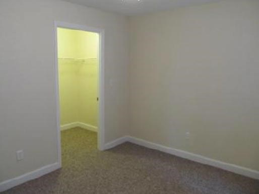 an empty room with a door to a yellow room