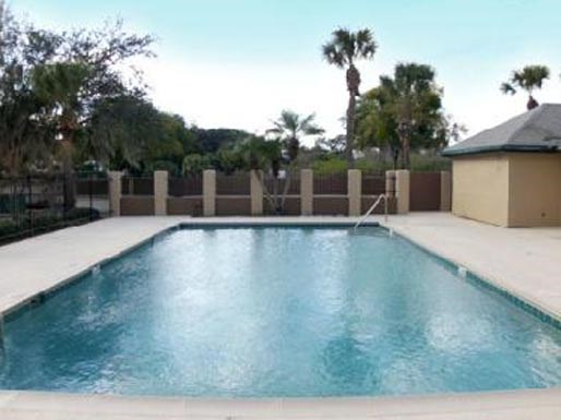a large swimming pool in the backyard of a house