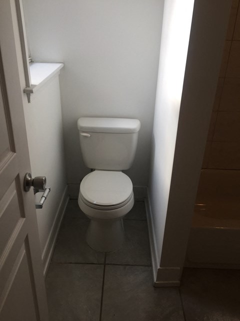 a small bathroom with a toilet and a door
