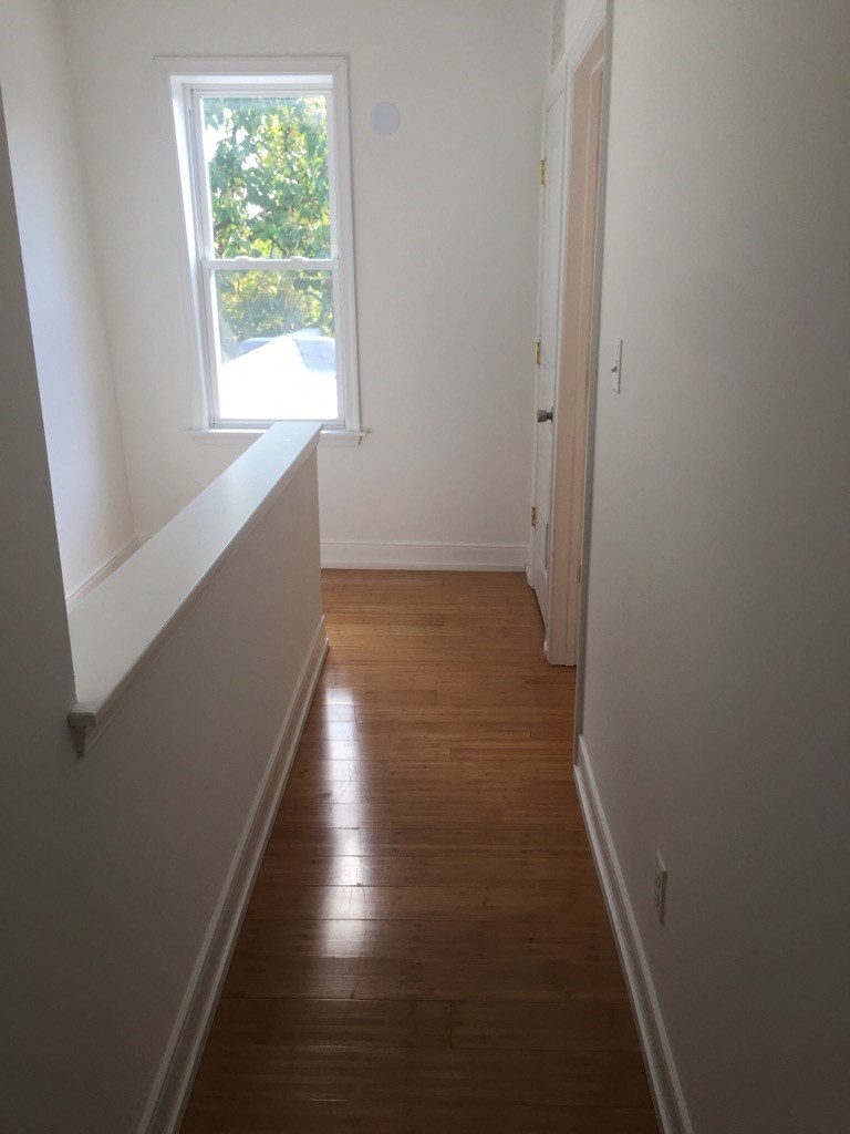 a room with a window and a wooden floor