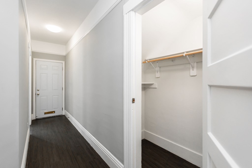 a room with white walls and a closet and a white door