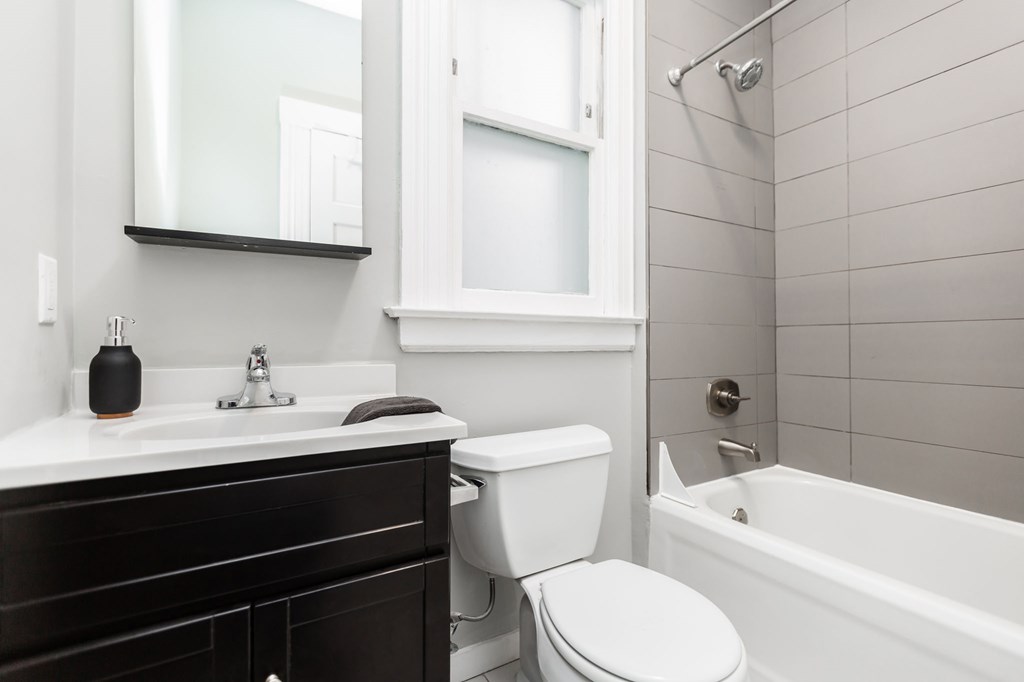 a bathroom with a sink toilet and a bath tub