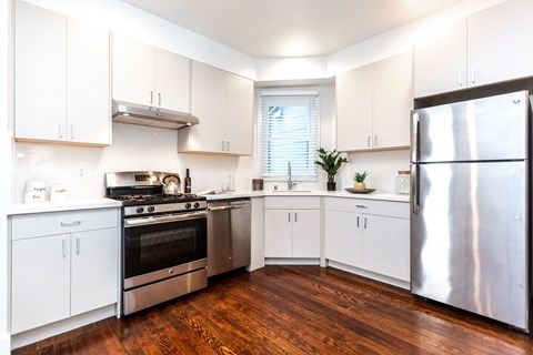 a kitchen with stainless steel appliances and white cabinets