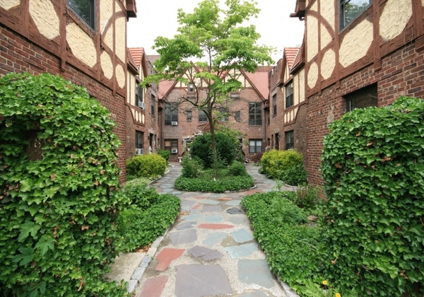 a walkway between buildings in a courtyard