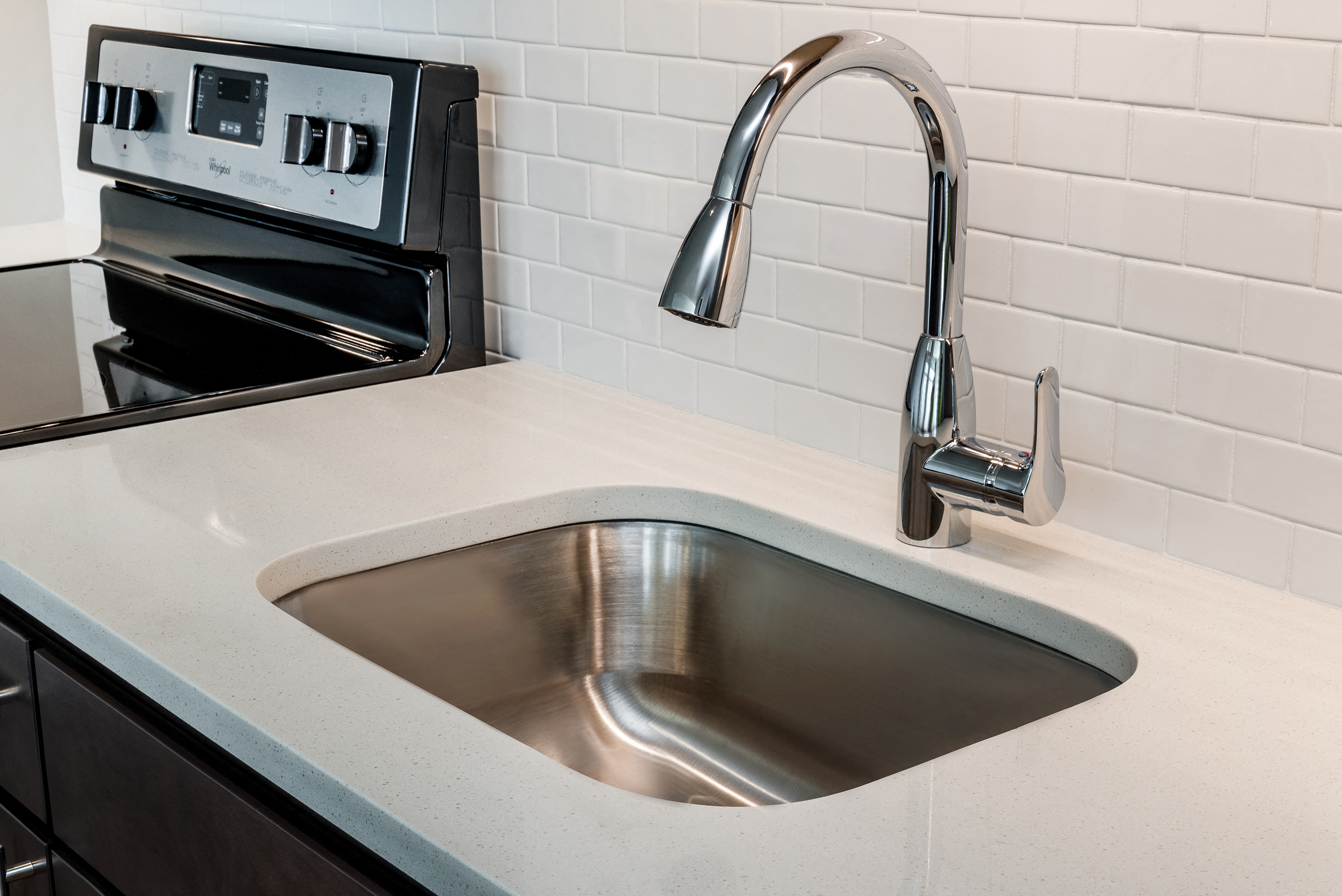 a sink in a kitchen with a chrome faucet
