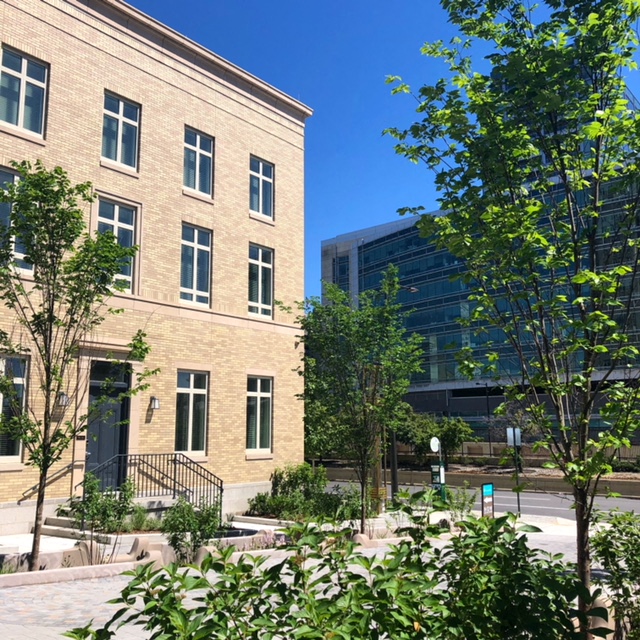 a large brick building with trees in front of it