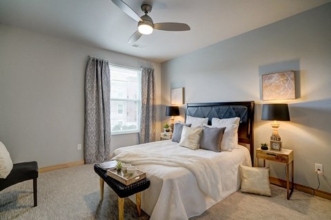 a bedroom with a bed and a ceiling fan