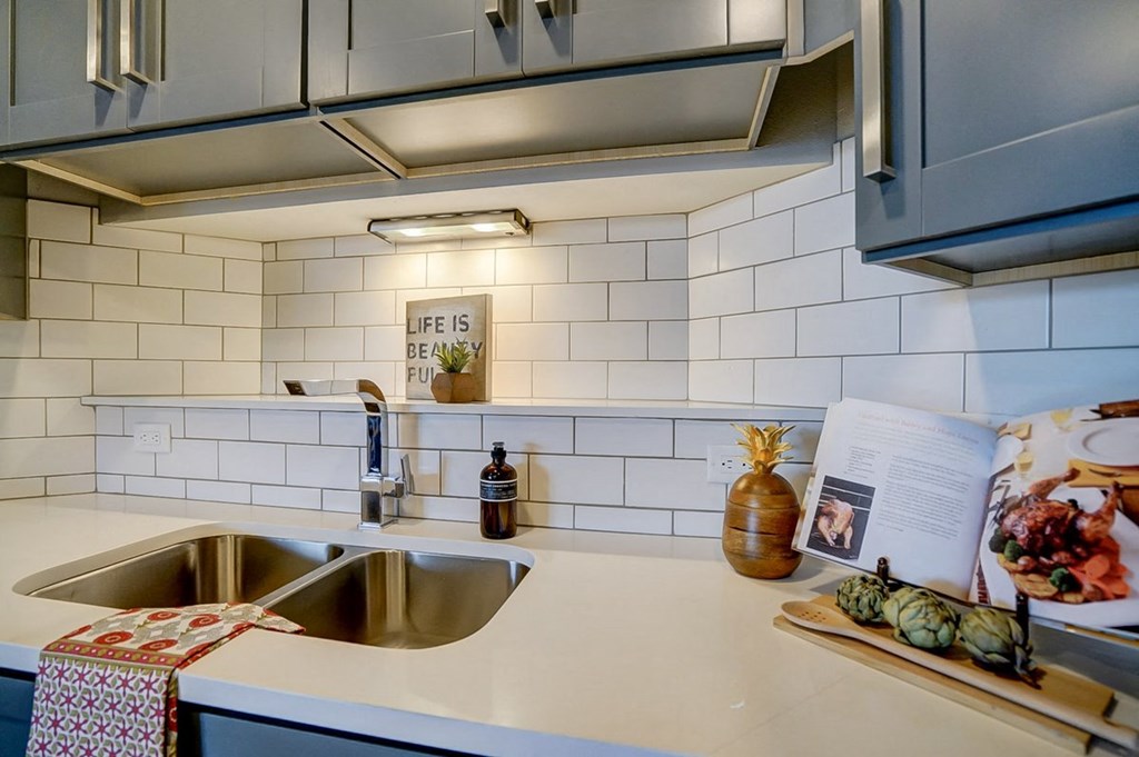 a kitchen with a sink and a book on the counter
