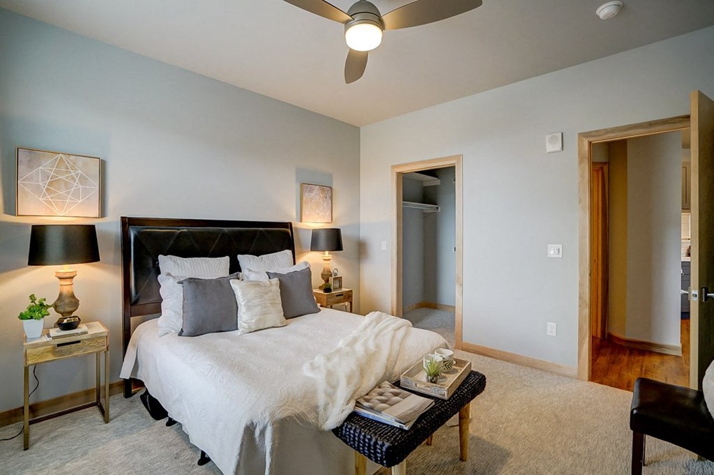 a bedroom with a large bed and a ceiling fan