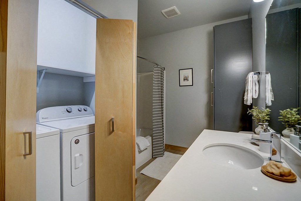 a laundry room with a sink and a washer and dryer in a bathroom