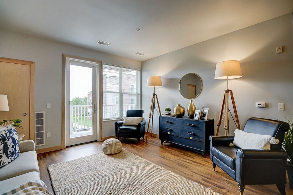 a living room with leather furniture and a sliding glass door