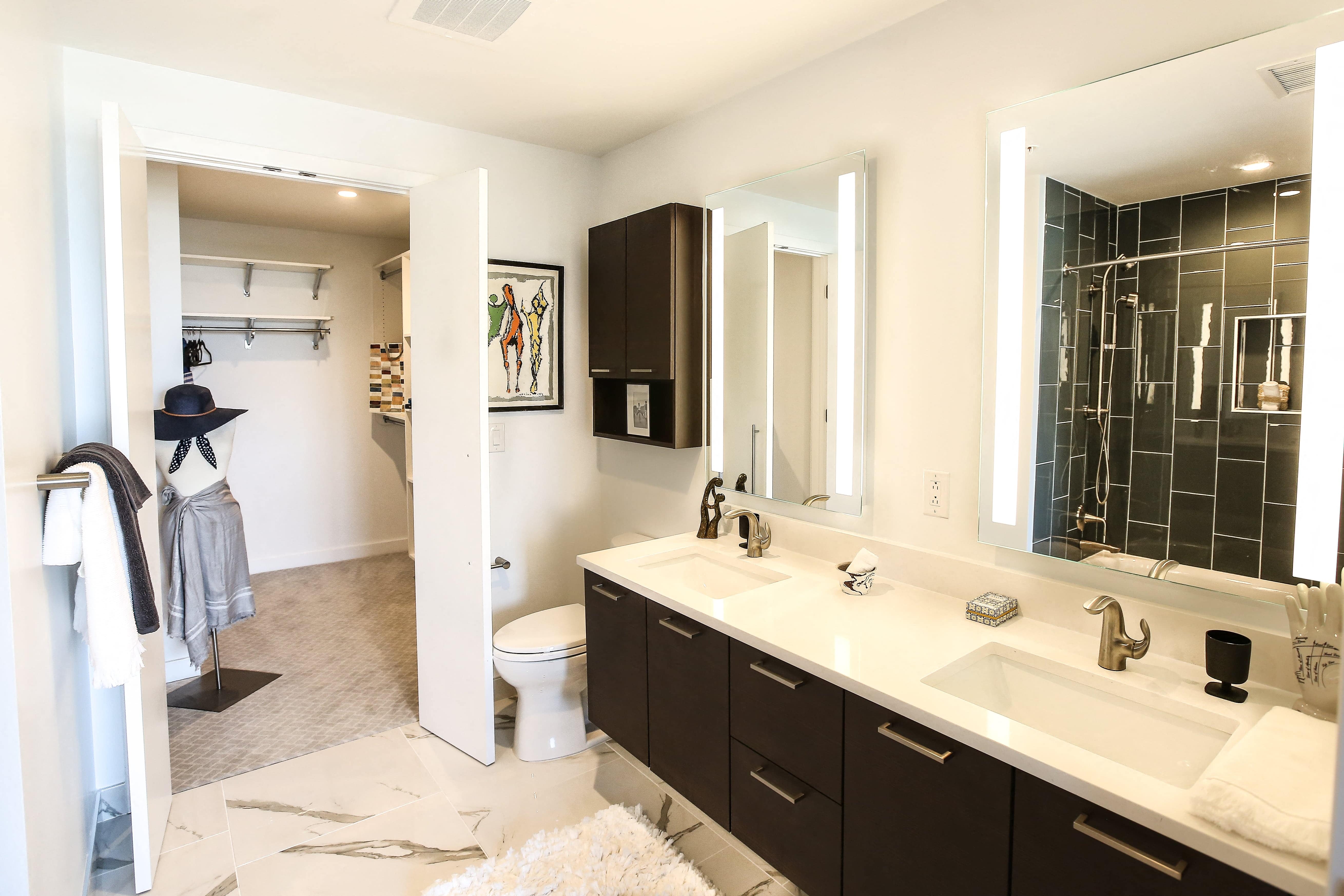 a bathroom with two sinks and a shower and a toilet