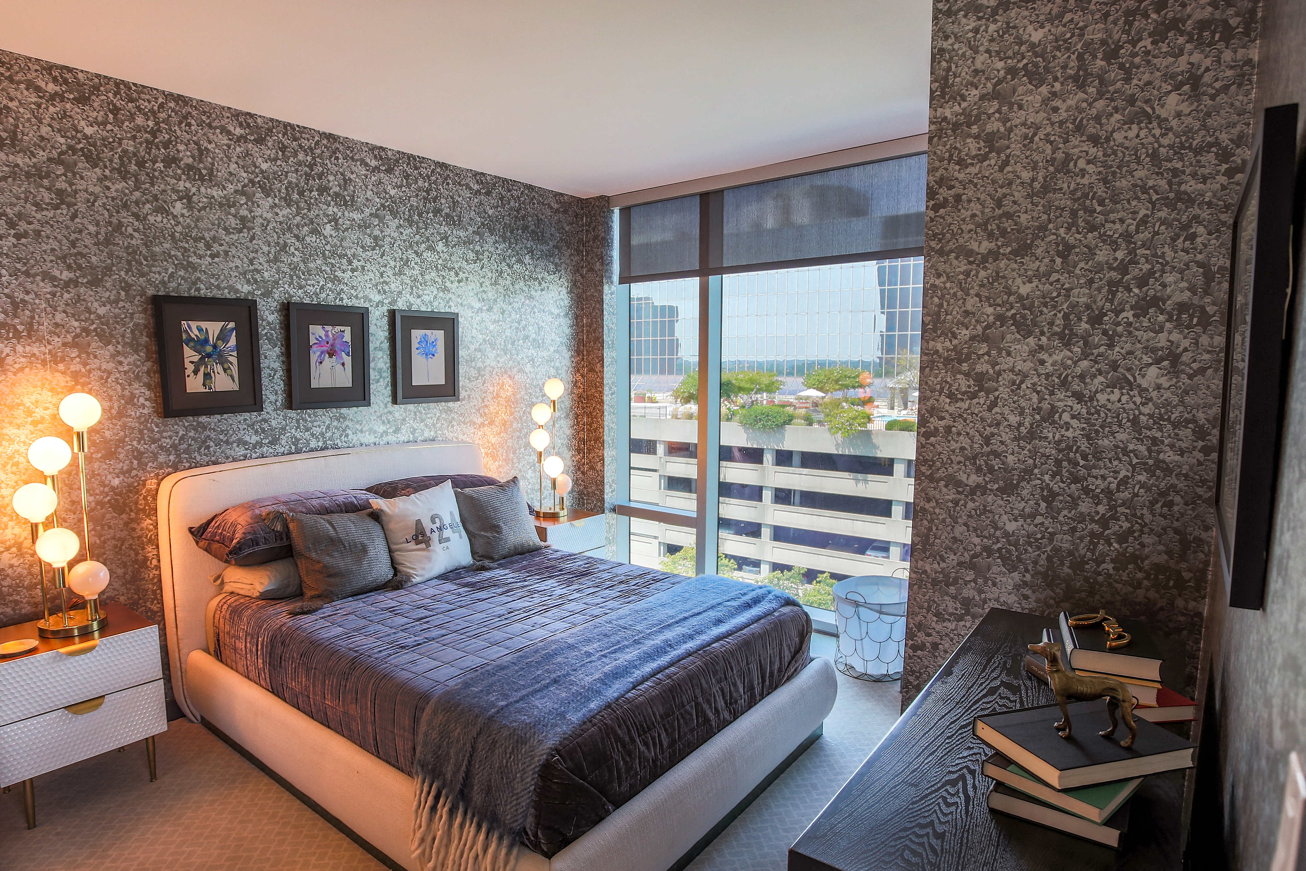 a bedroom with a bed and a large window