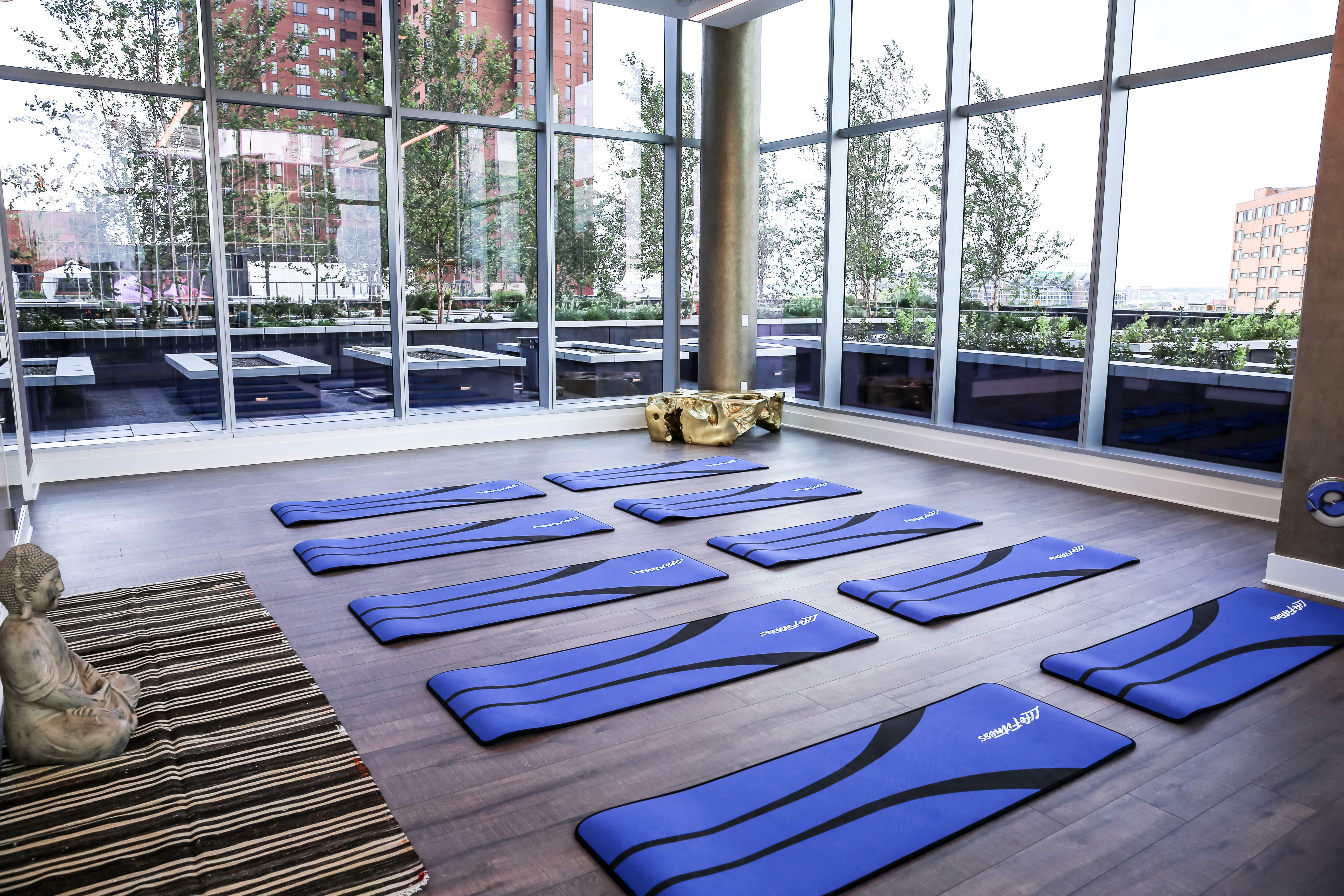 a group of blue yoga mats on the floor in front of a window