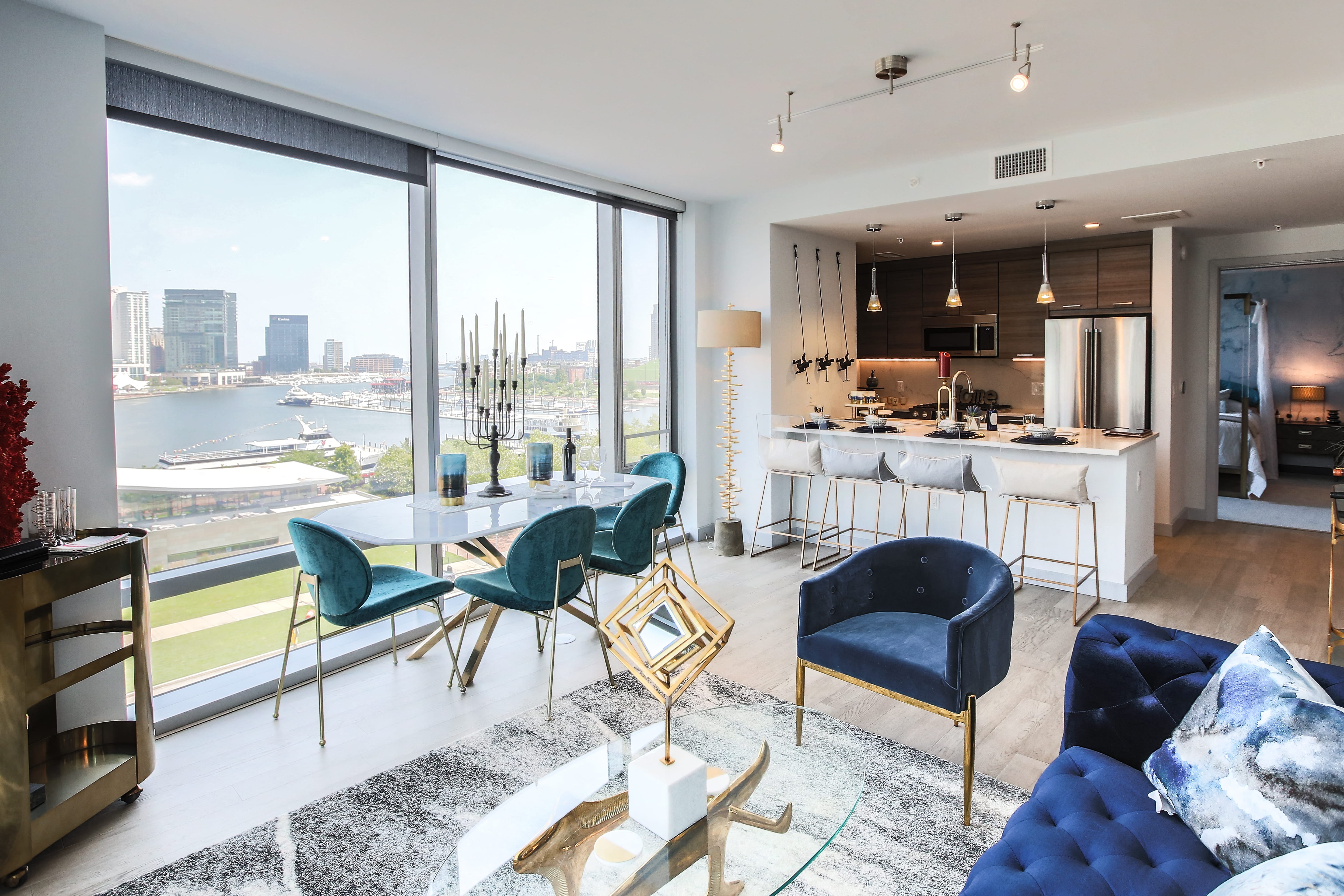 a living room and kitchen with a view of a river and a city