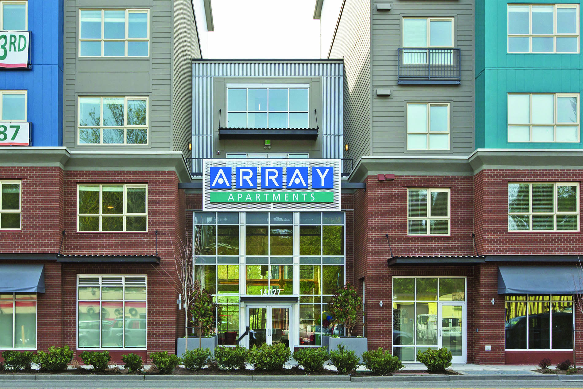 The front of a building with a sign that says "ARRAY Apartments".