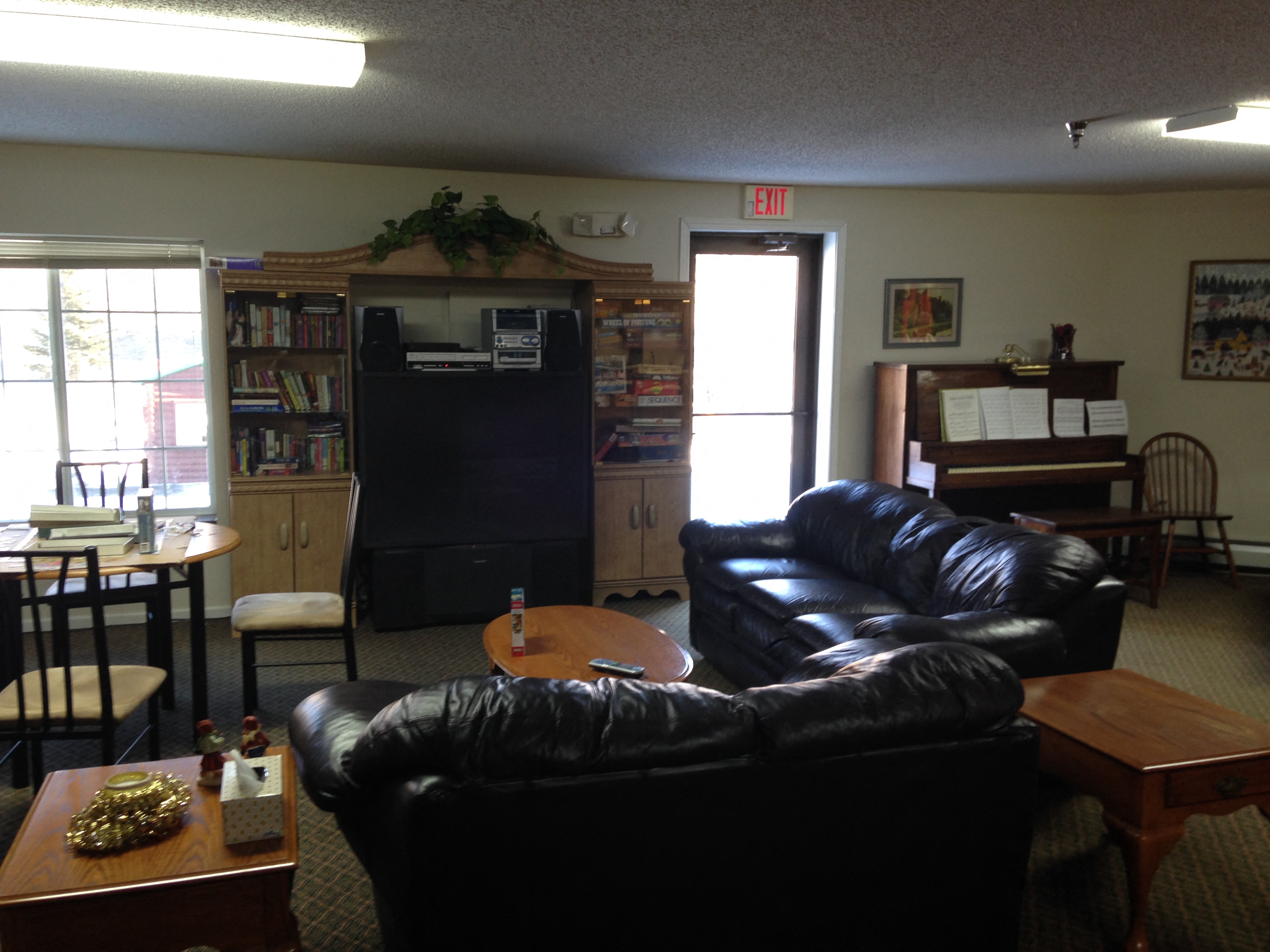 a living room with leather couches and a table and a television