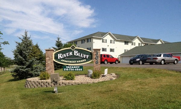 a river bluff resort sign in front of a building