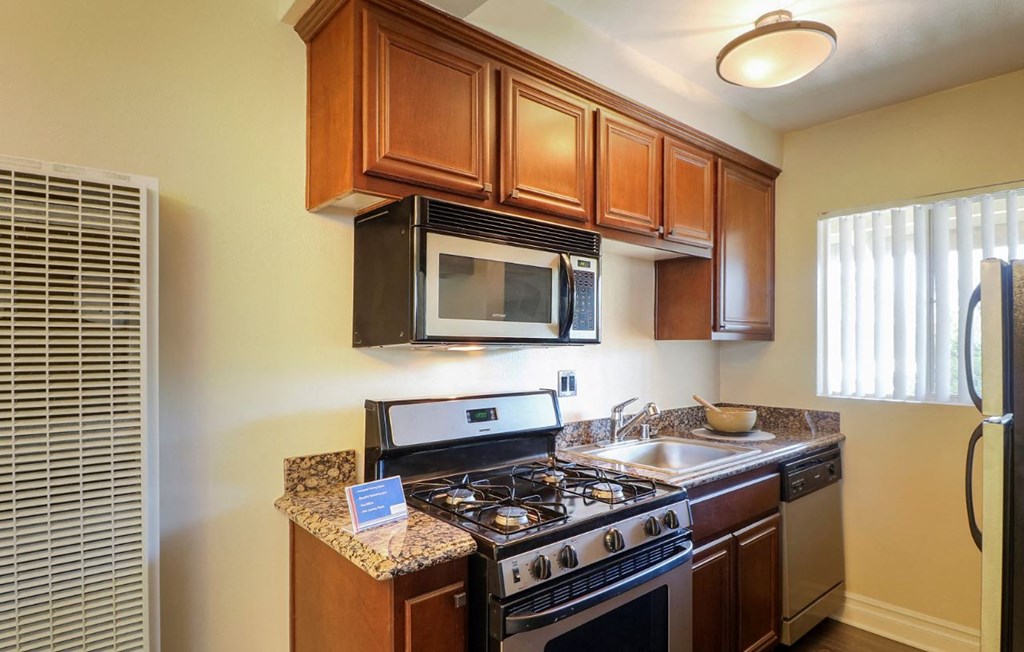 a kitchen with a stove microwave and a sink