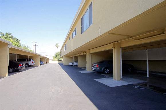 a parking lot with cars parked under a building
