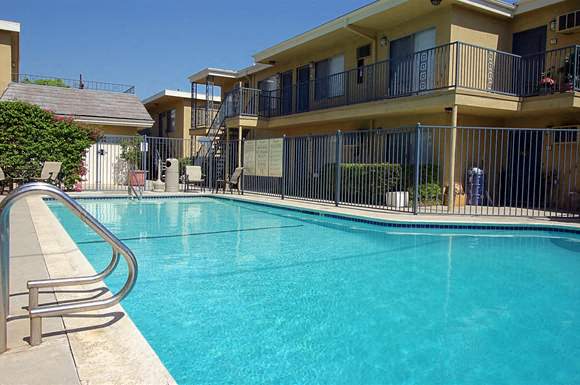 a large swimming pool in front of a hotel